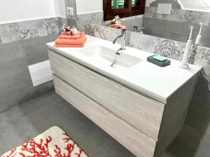 a bathroom with a sink and a mirror at Villa Alzoni in San Teodoro