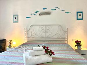 a bedroom with a bed with fish on the wall at Villa Alzoni in San Teodoro