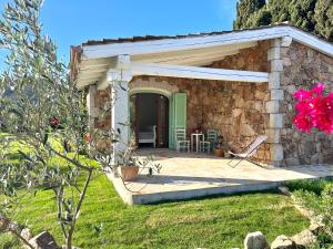 a stone house with a porch and a patio at Villa Alzoni in San Teodoro