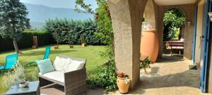 a patio with two chairs and a table and a table at Chambre D'hôtes La Grande Calade in Lagrand +9 photos