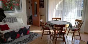 a living room with a table and chairs and a bed at Chambre D'hôtes La Grande Calade in Lagrand