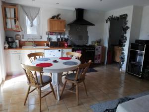 a kitchen with a table and chairs in a kitchen at Chambre D'hôtes La Grande Calade in Lagrand