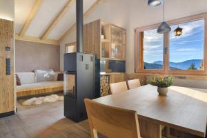 a kitchen and dining room with a table and a couch at Chalet Hugo in Verano