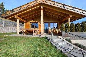 a wooden pavilion with a wooden table in a yard at Chalet Hugo in Verano