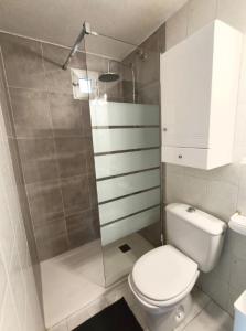 a white bathroom with a toilet and a shower at R-06 Holiday Apartment La Mata in La Mata