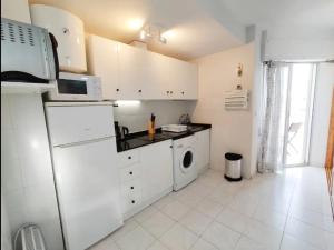 a kitchen with a refrigerator and a washing machine at R-06 Holiday Apartment La Mata in La Mata