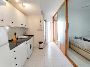 a kitchen with a sink and a washing machine at R-06 Holiday Apartment La Mata in La Mata +3 photos