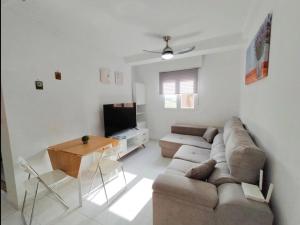 a living room with a couch and a table at R-06 Holiday Apartment La Mata in La Mata