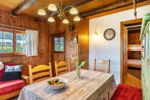 a dining room with a wooden table and chairs at Blockhaus Paepke in Mühlenbach