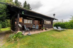 a log cabin with a table and chairs in the yard at Blockhaus Paepke in Mühlenbach