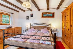 a bedroom with a bed with pink pillows at Blockhaus Paepke in Mühlenbach
