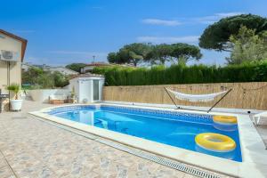 a swimming pool with two yellow frisbees in it at Villa Pura Vida by Easy Brava in Calonge