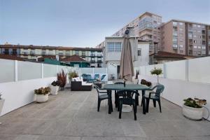 a patio with a table and chairs on a roof at Douro Garden Home Rooftop in Vila Nova de Gaia