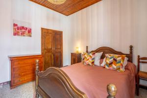a bedroom with a wooden bed and a wooden dresser at Maison de pecheurs in Valras-Plage