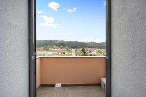 a door to a balcony with a view at Antichi Ricordi - Il Nido in Marina di Andora