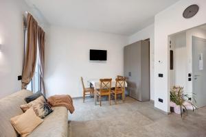 a living room with a couch and a table at Antichi Ricordi - Il Nido in Marina di Andora