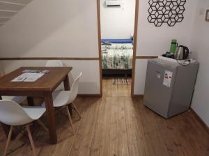 a room with a table and a small refrigerator at Cerro Chaltén House - Deptos in El Chalten