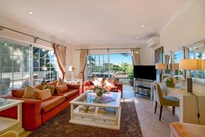 a living room with a couch and a table at Casa Valerie in Vale do Lobo