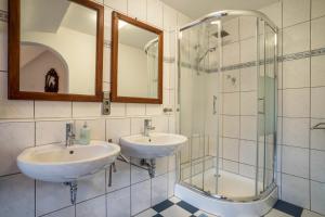 a bathroom with two sinks and a shower at Lehmann mit Blick aufs Schloss in Gutach +14 photos