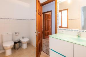 a bathroom with a toilet and a sink at Casa Coronel Aloy in Pollença +20 photos