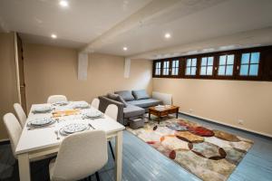 a living room with a table and a couch at Murmures de la Risle in Pont-Audemer