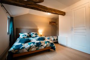 a bedroom with two beds in a room at Murmures de la Risle in Pont-Audemer