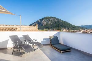 a group of chairs on a balcony with a mountain at Casa Coronel Aloy in Pollença