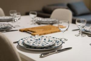 a table with plates and wine glasses on it at Murmures de la Risle in Pont-Audemer +15 photos
