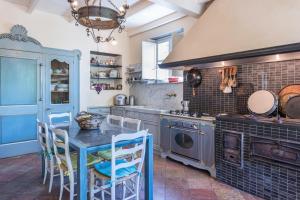 a kitchen with a blue table and chairs at Ca dei gruppi in Cicagna