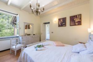 a bedroom with a white bed and a window at Ca dei gruppi in Cicagna +32 photos