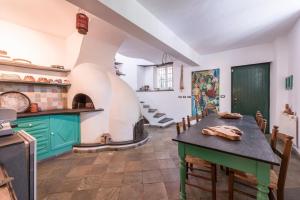 a kitchen with a table and a pizza oven at Ca dei gruppi in Cicagna