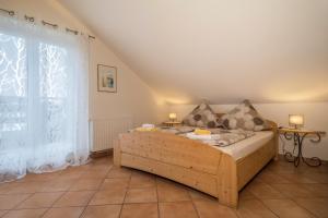 a bedroom with a bed and a large window at Haus Sonnenseite Wohnung Pfänder in Wasserburg