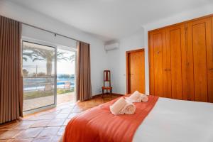 a bedroom with a bed with a view of the ocean at Villa Las Rosas in Albufeira +34 photos