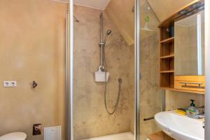 a shower in a bathroom with a toilet and a sink at Eule in Donaueschingen +13 photos