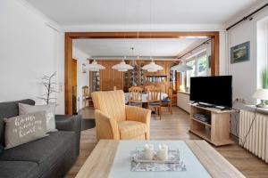 a living room with a couch and a table at Haus Gerda in Stadum