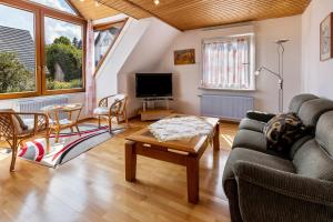 a living room with a couch and a table at Eule in Donaueschingen