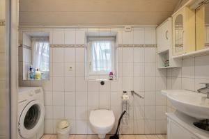 a bathroom with a washing machine and a sink at Haus Gerda in Stadum +19 photos