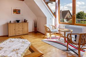 a living room with chairs and a table and a window at Eule in Donaueschingen