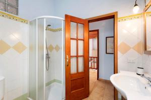 a bathroom with a shower and a tub and a sink at La Huerta in Hermigua +22 photos