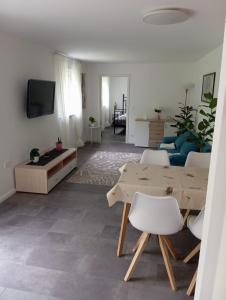 a living room with a table and a couch at Villa am Bacho in Dörzbach