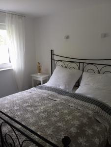 a bedroom with a large bed with white pillows at Villa am Bacho in Dörzbach