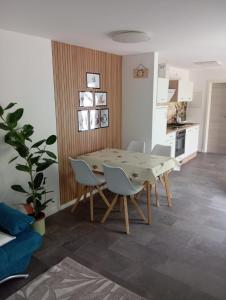 a dining room with a wooden table and chairs at Villa am Bacho in Dörzbach