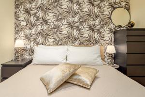 a bedroom with a bed with a large headboard at Villa Caterina in Punta Molara +18 photos