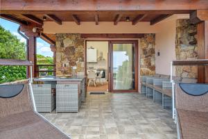 an outdoor kitchen and dining area of a house at Villa Caterina in Punta Molara