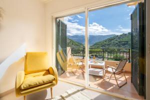 a room with a balcony with a table and chairs at Soller beach apartment in Sóller
