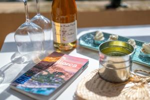 a table with a book and a bottle of wine at Soller beach apartment in Sóller +19 photos
