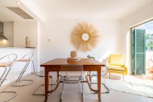 a dining room with a wooden table and chairs at Soller beach apartment in Sóller
