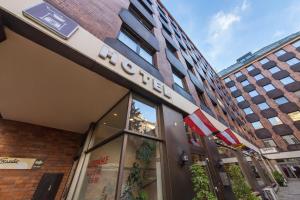 a building with a hotel sign on the front of it at Hotel Kaffeemühle in Vienna +48 photos