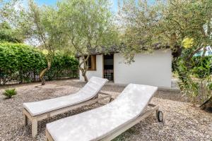 two lounge chairs in a yard with trees at Casa La Castañuela in El Palmar
