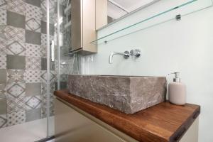 a bathroom with a stone sink and a shower at Giada's Retreat - Genova Nervi in Genoa +19 photos